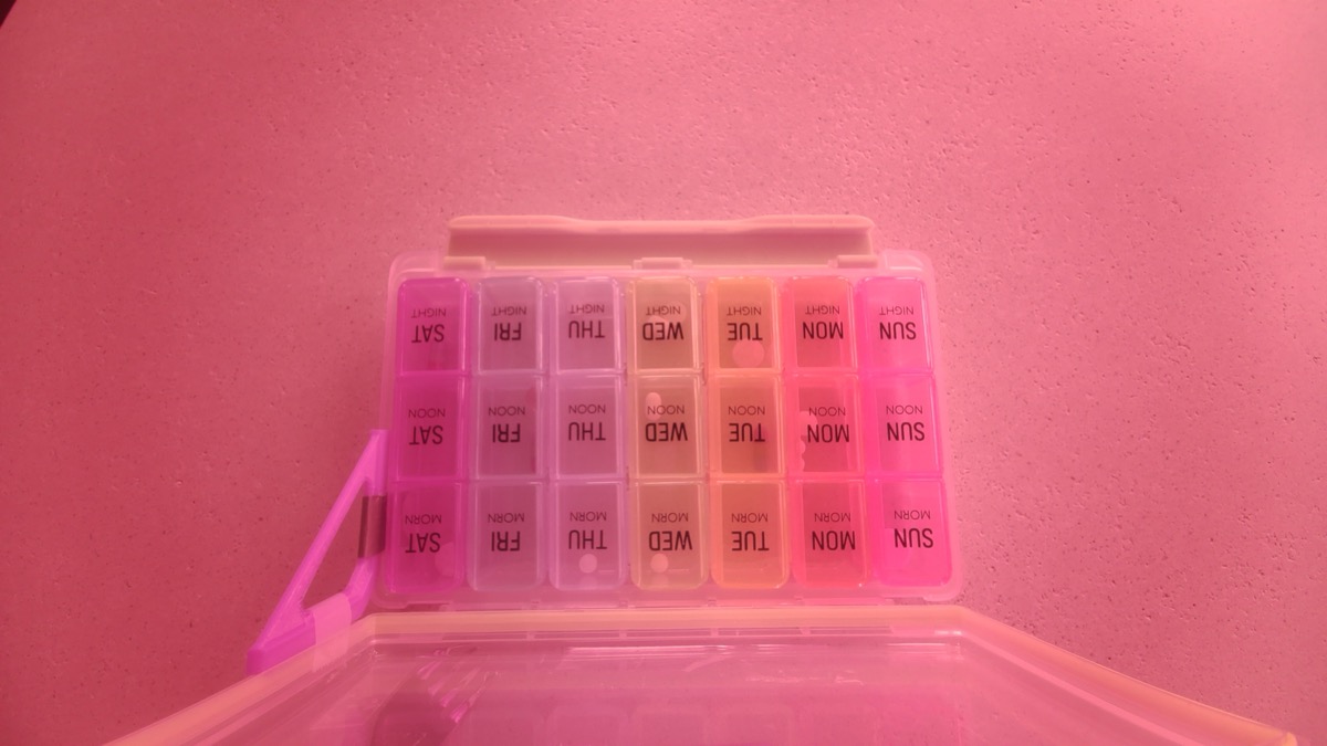 A raw capture from the PillWatch Raspberry Pi camera rig: the 21-cell pill organizer photographed from above